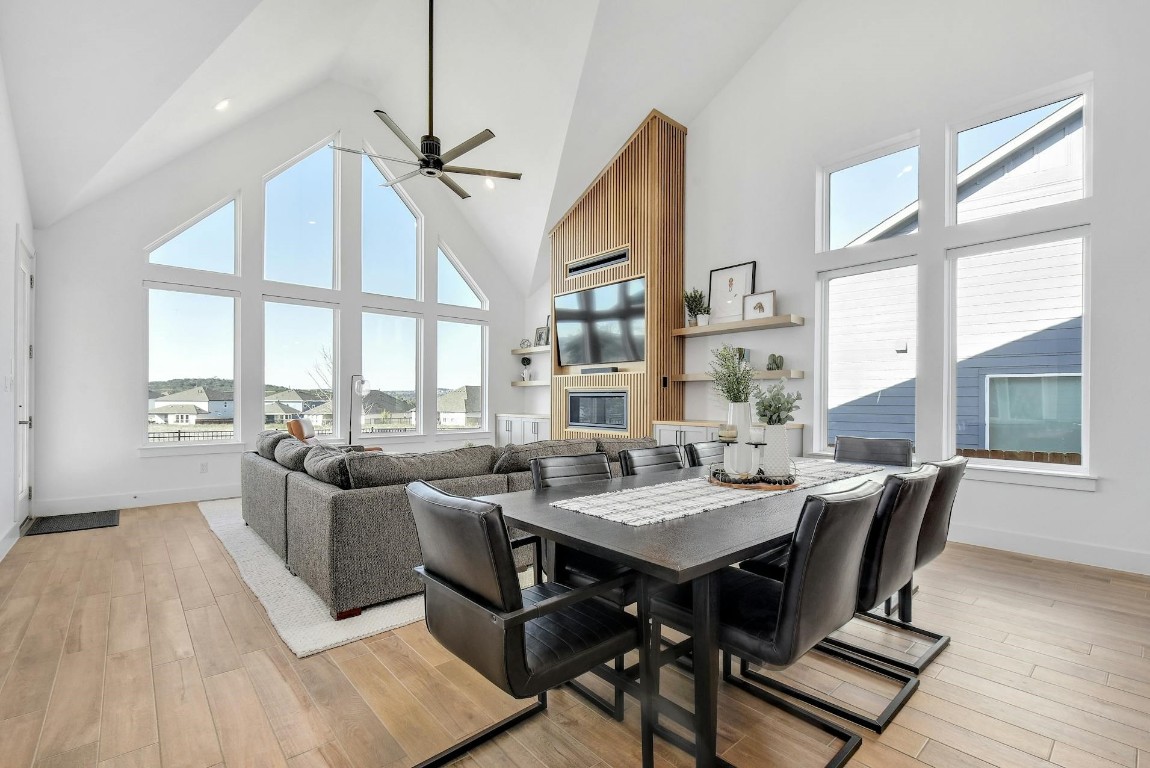 a view of a dining room with furniture large windows and wooden floor