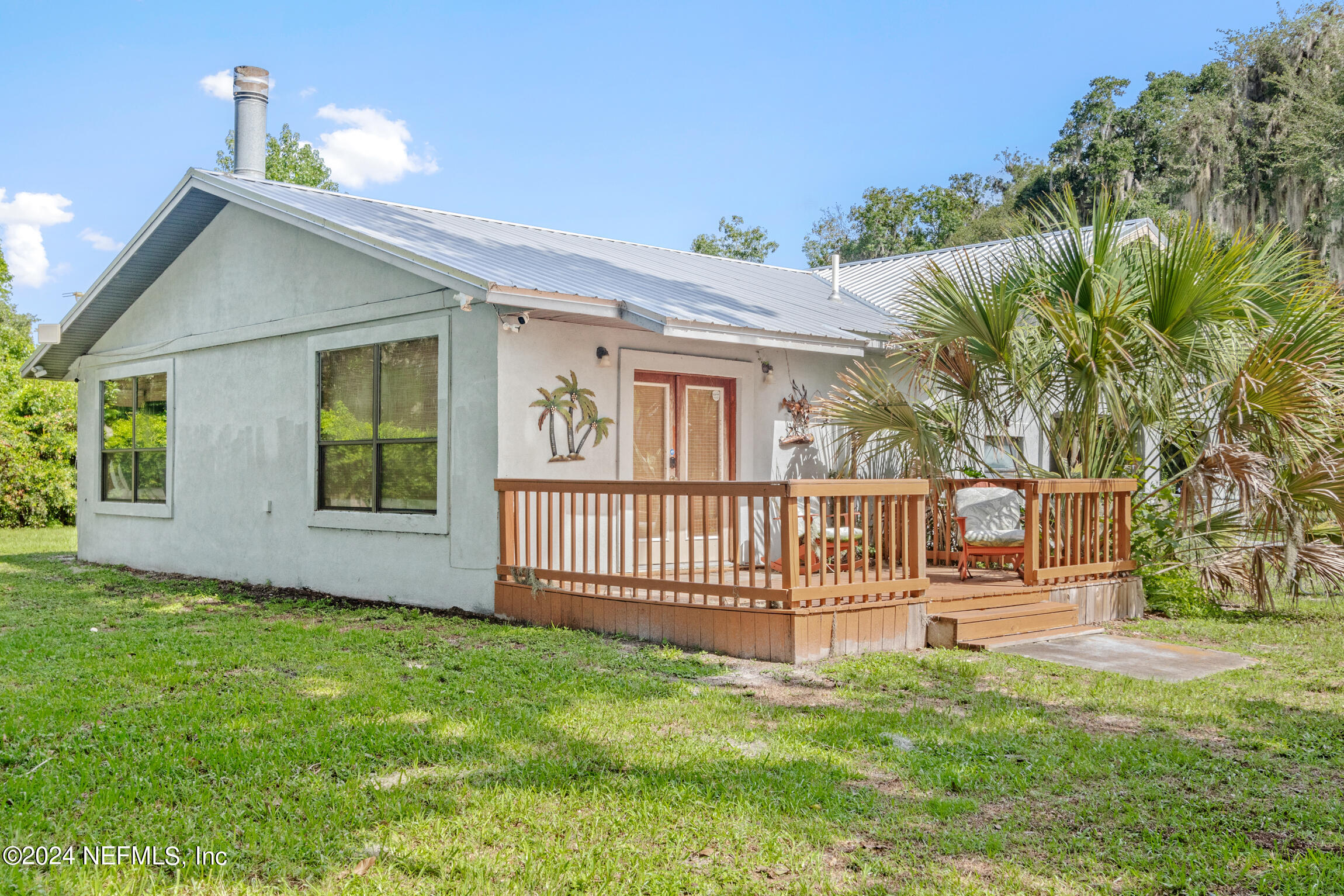 a view of a house with a yard and deck