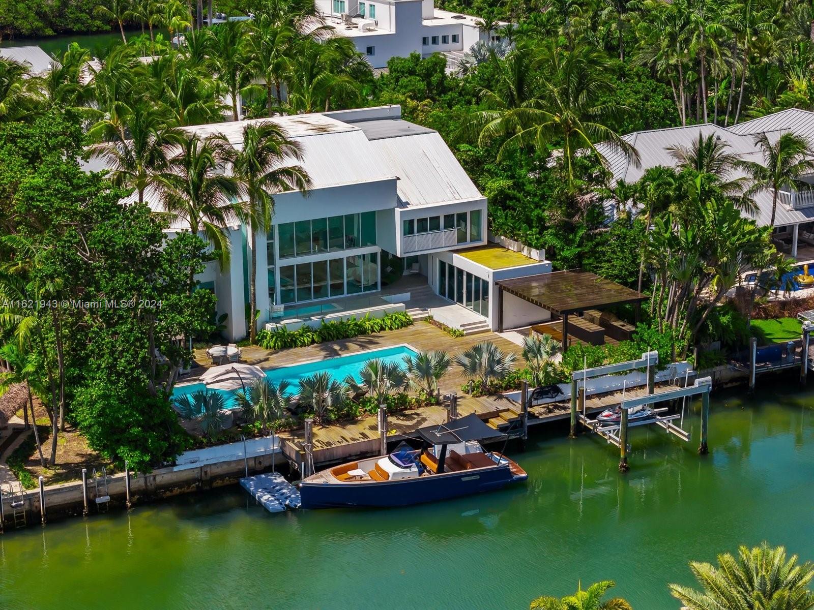 an aerial view of a house with a garden and swimming pool