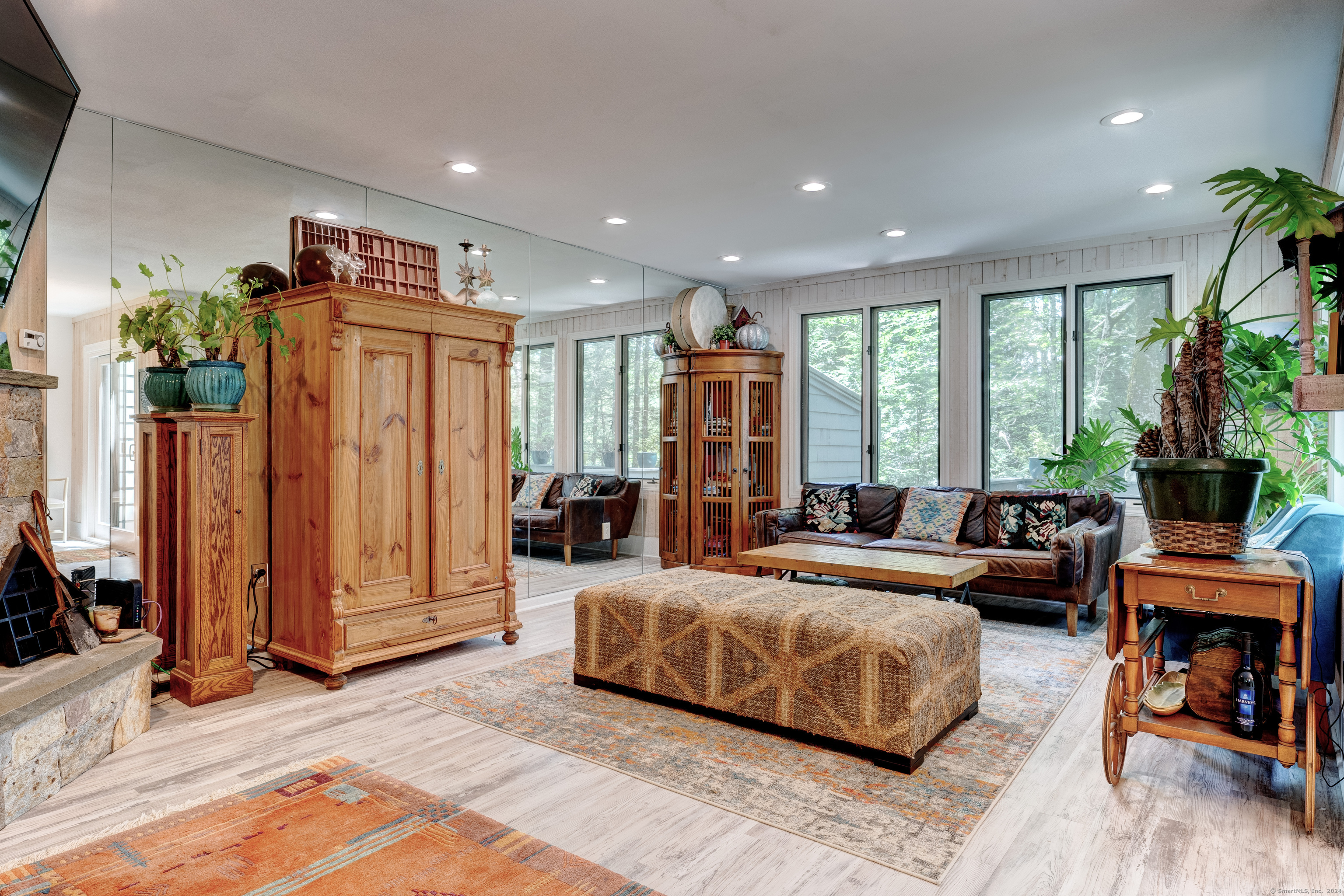 a spacious bedroom with a bed a couch and a potted plant