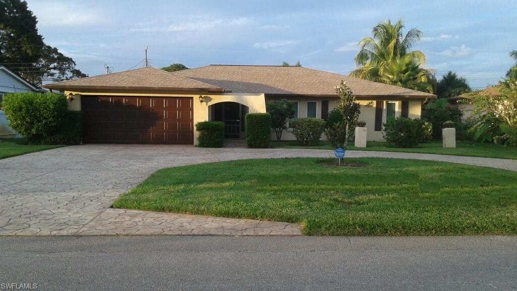 Ranch-style home with a garage and a front yard