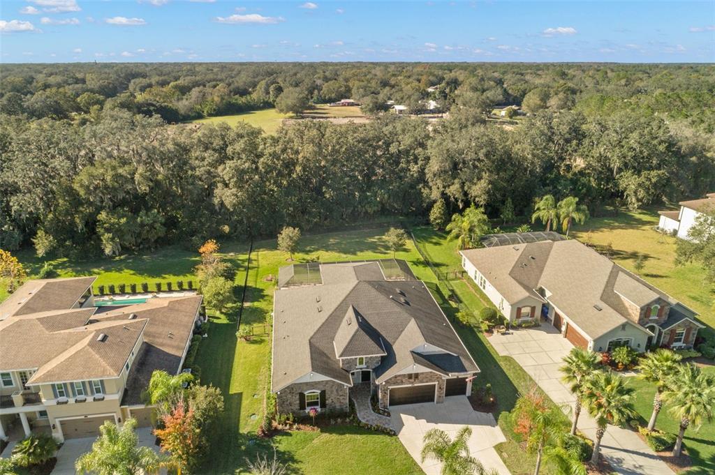 an aerial view of residential houses with outdoor space and swimming pool