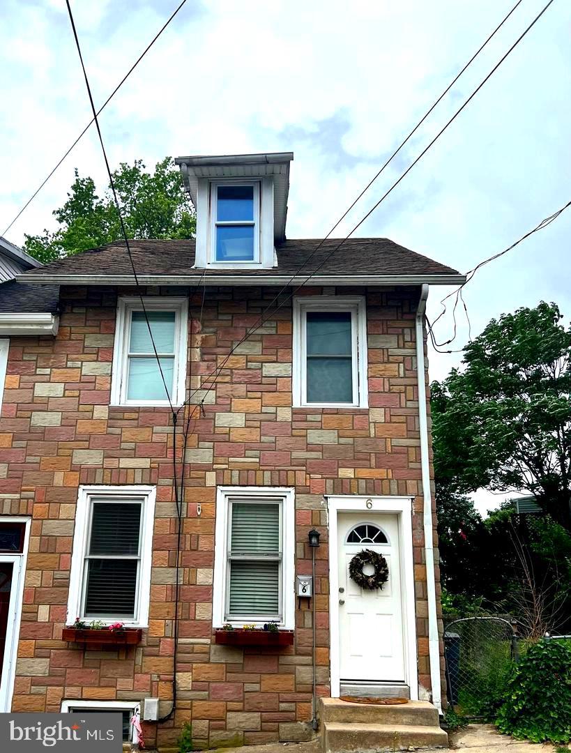 a view of brick house with a large windows