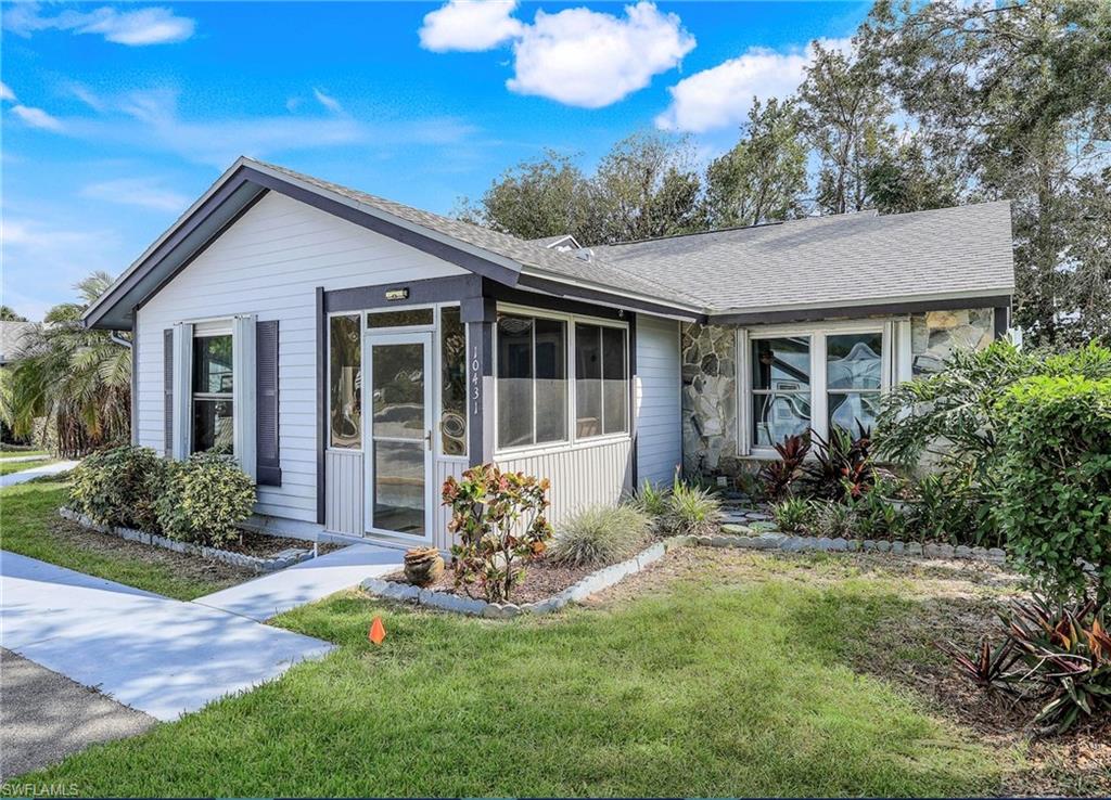 Property with a front yard and a sunroom