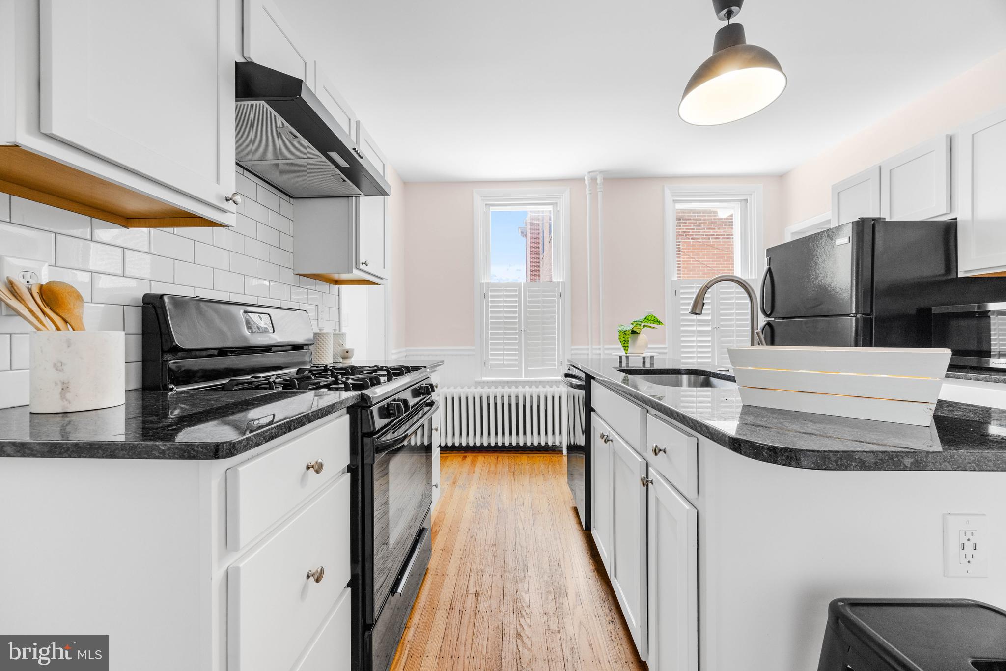 a kitchen with stainless steel appliances granite countertop a stove and a sink