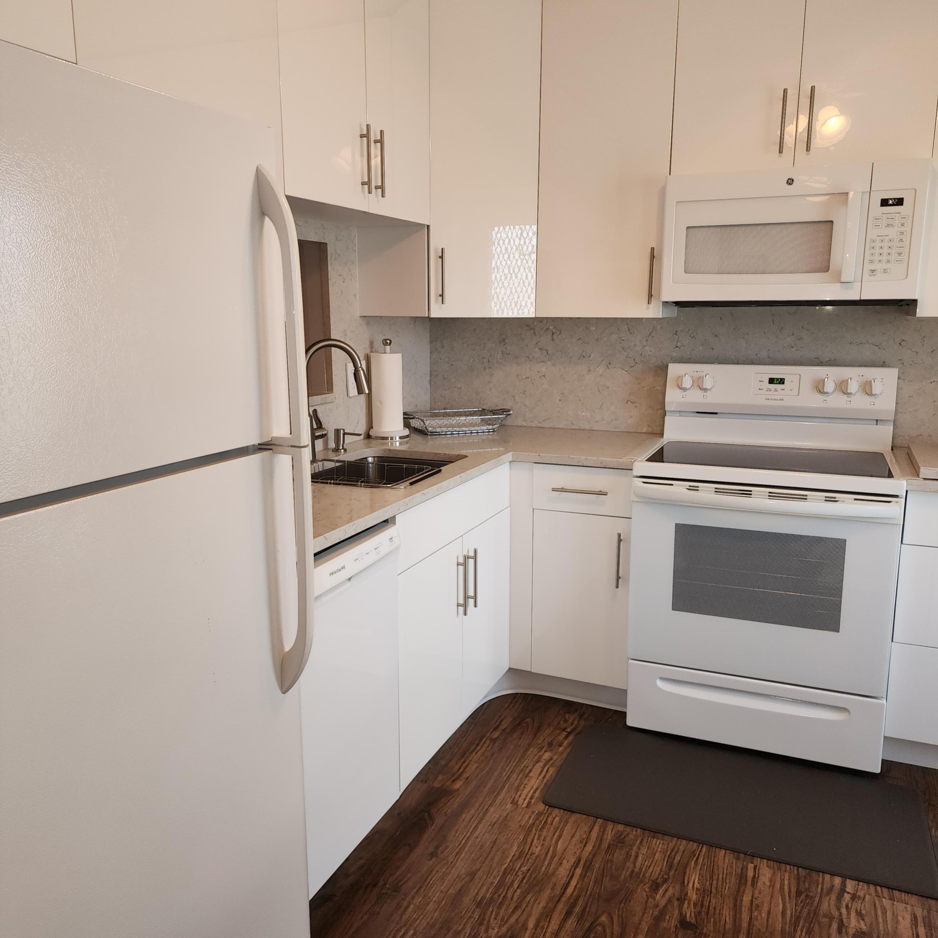 a kitchen with a stove oven and white cabinets