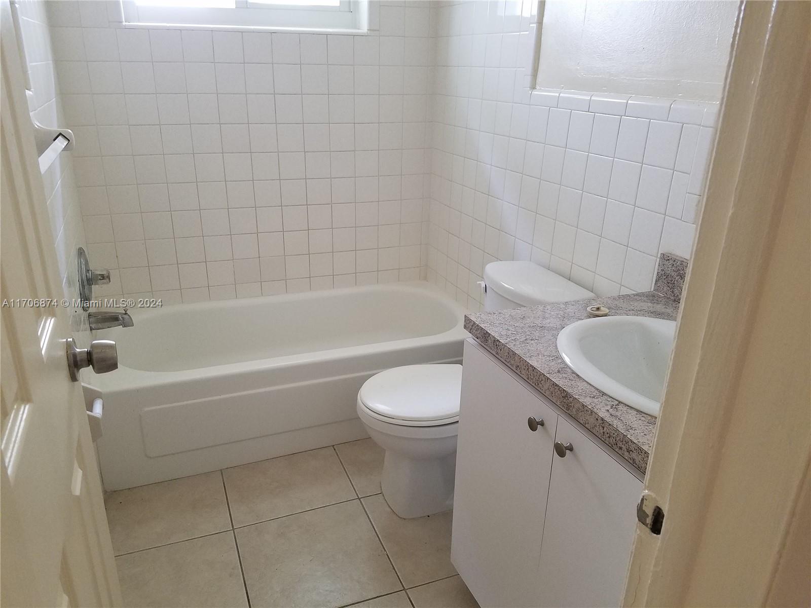 a bathroom with a sink a toilet and bathtub