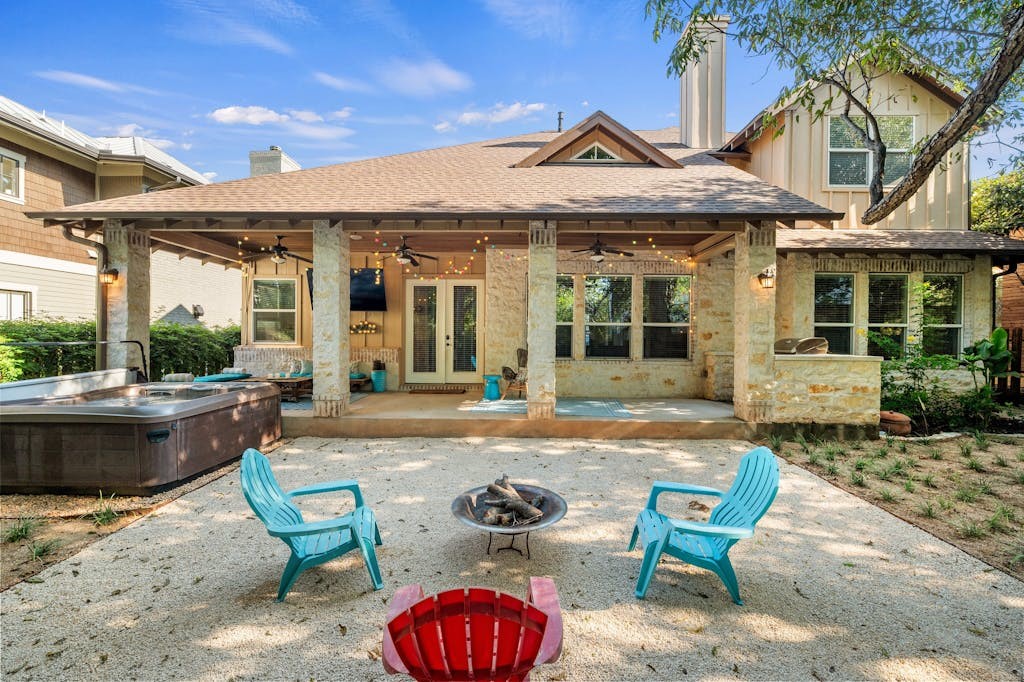 a view of a house with swimming pool and sitting area