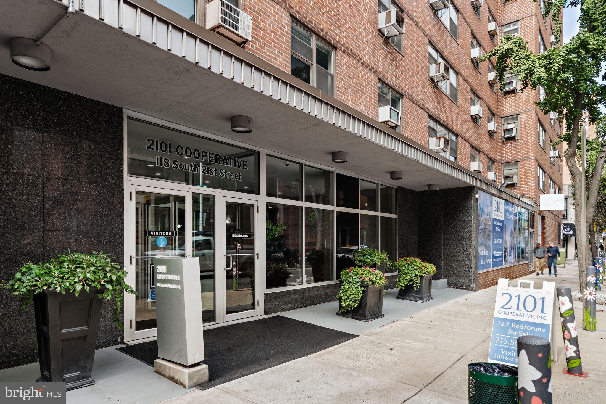 a front view of a building with potted plants