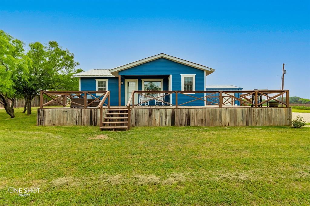 a view of a house with a yard and deck