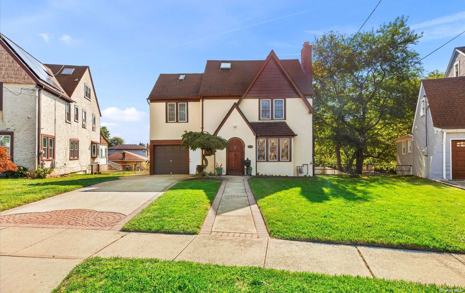 a front view of house with yard and green space