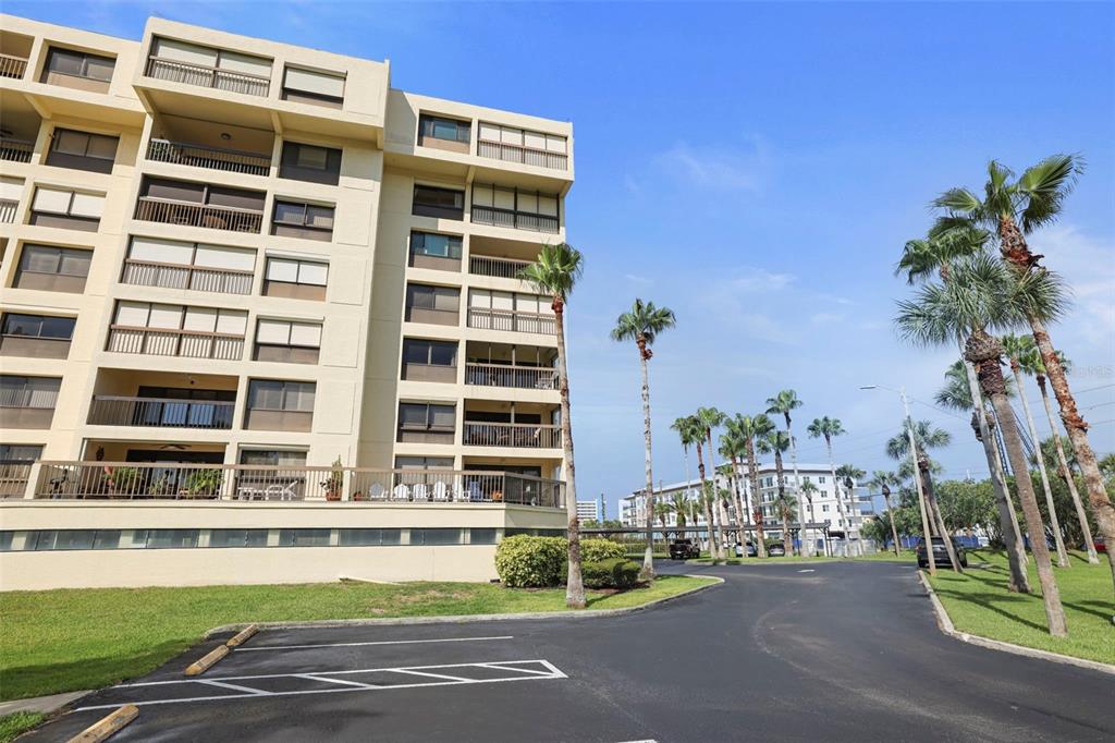 a view of a tall building next to a yard