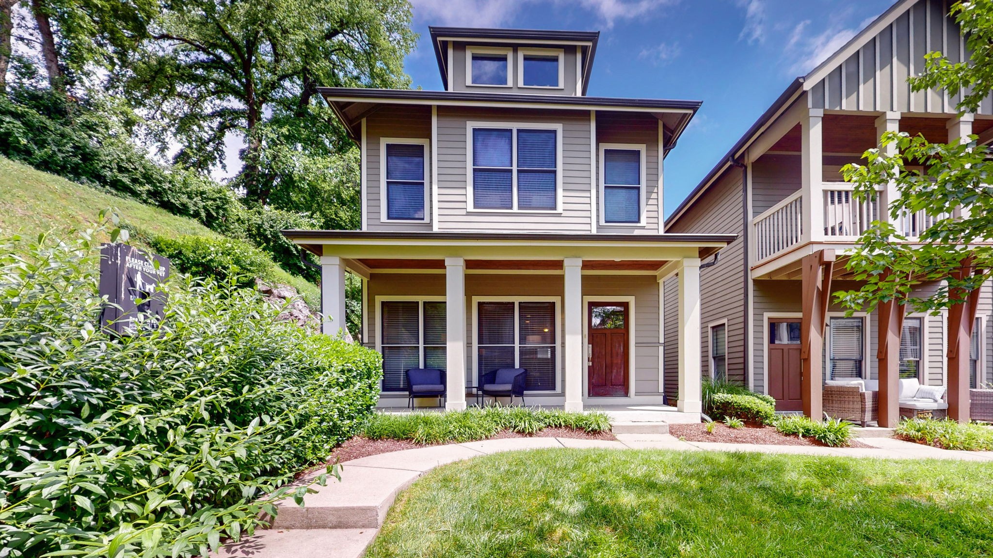 front view of a brick house with a yard