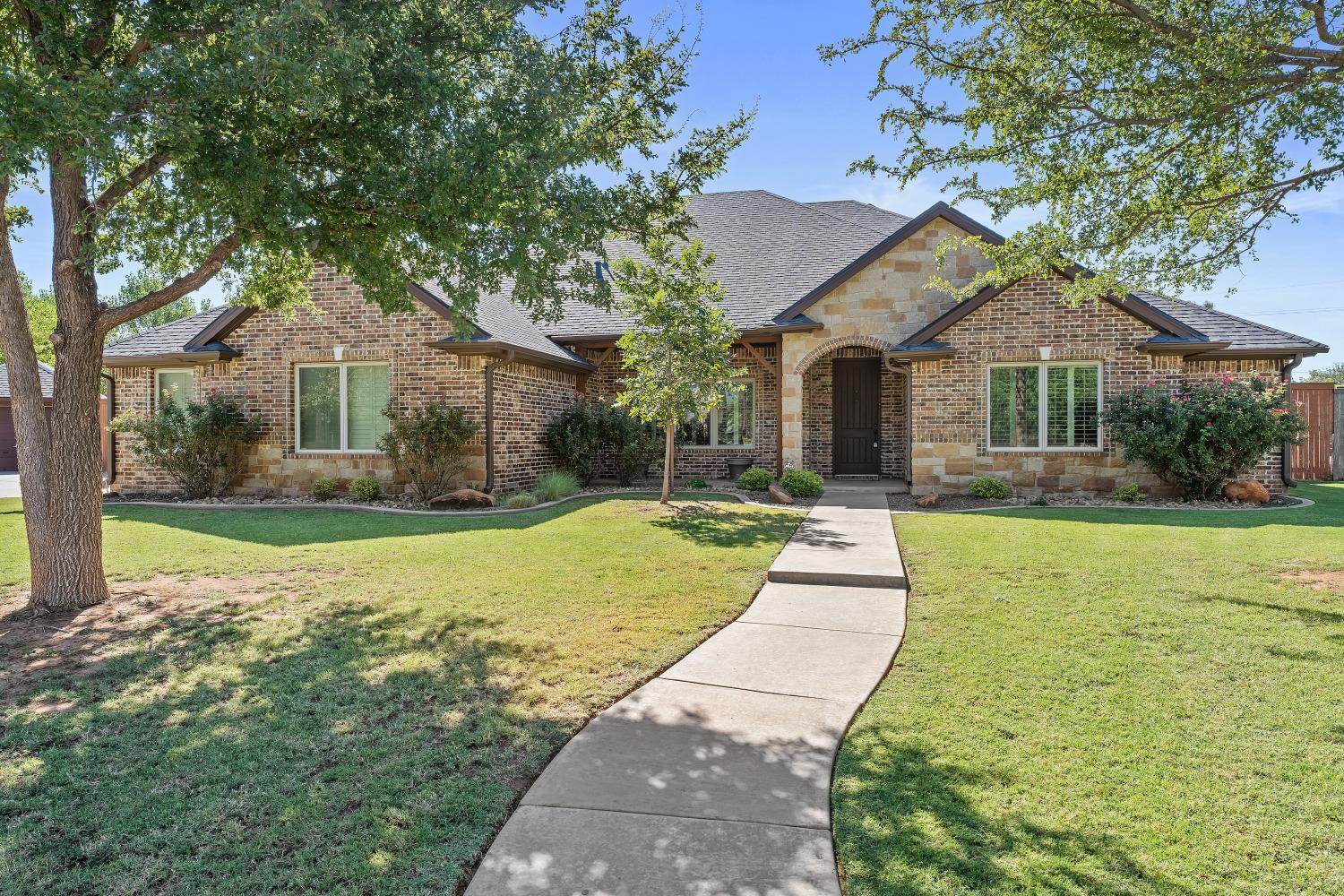 a front view of a house with yard