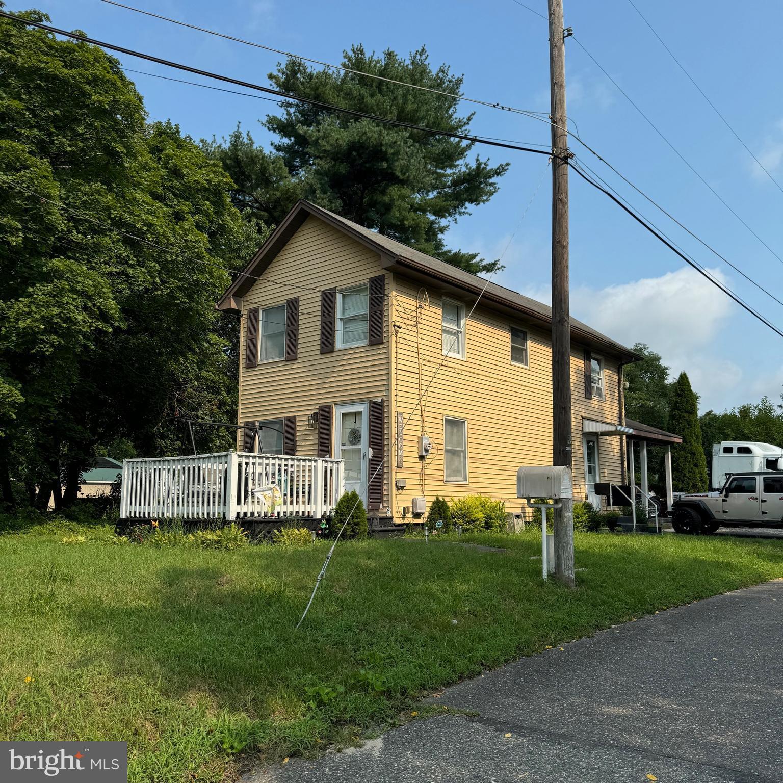 a view of house with a yard