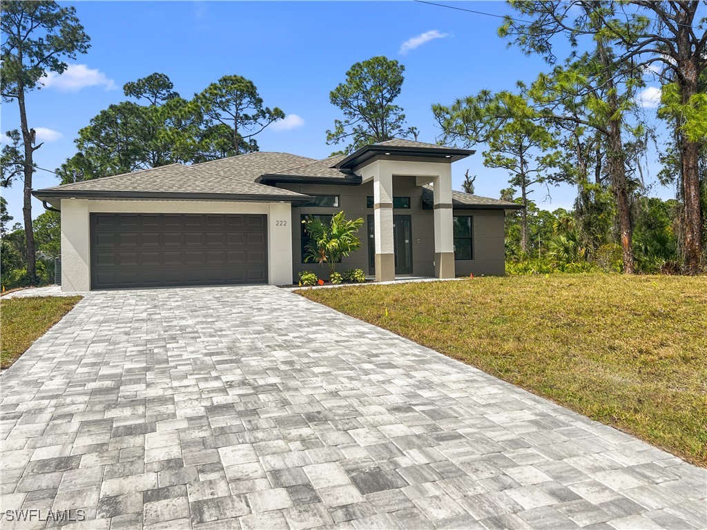 a front view of a house with a yard and garage