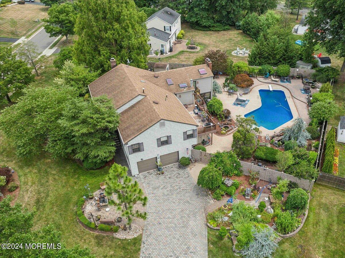 an aerial view of a house with a garden and swimming pool