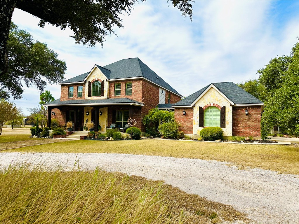 a front view of a house with a yard and porch