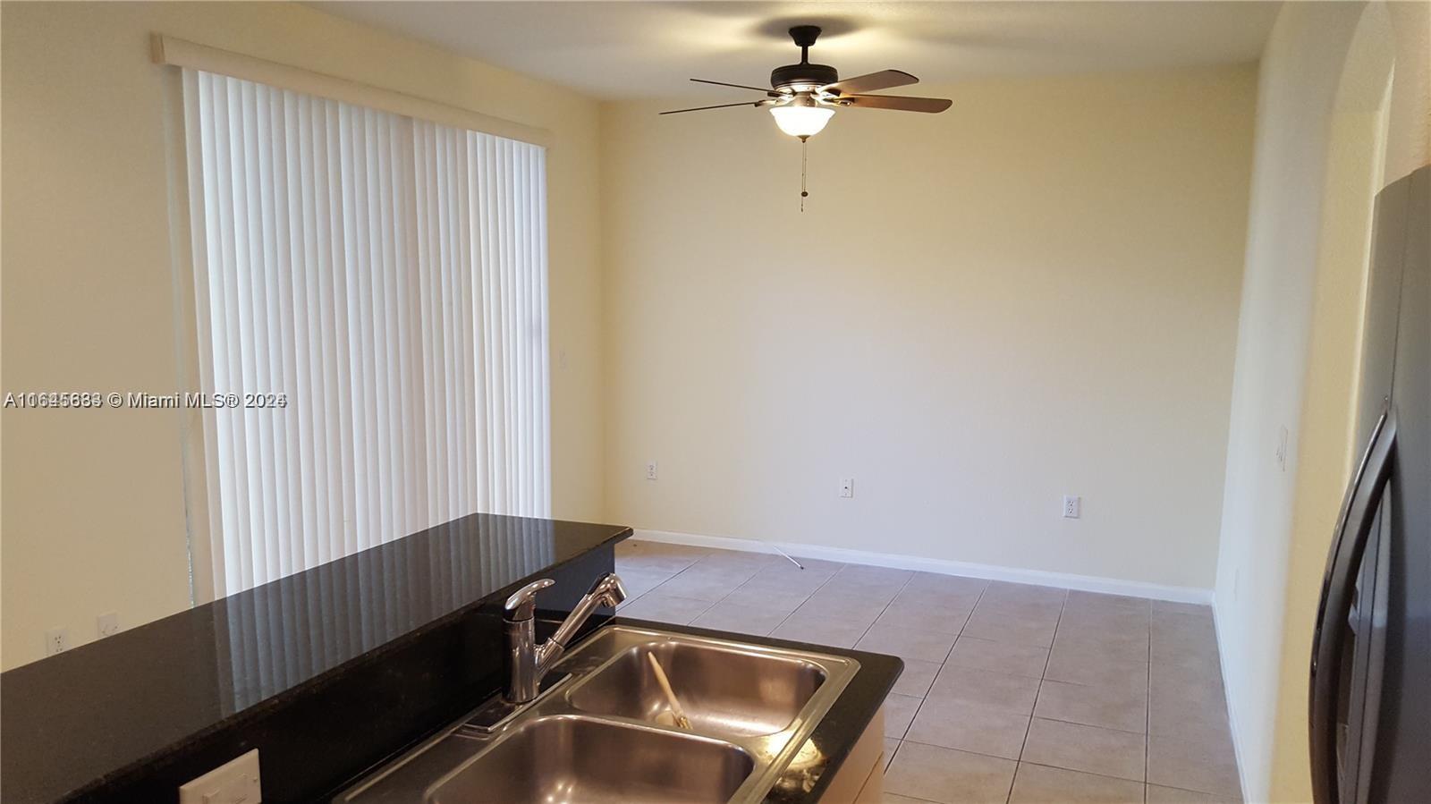 a view of room with a ceiling fan