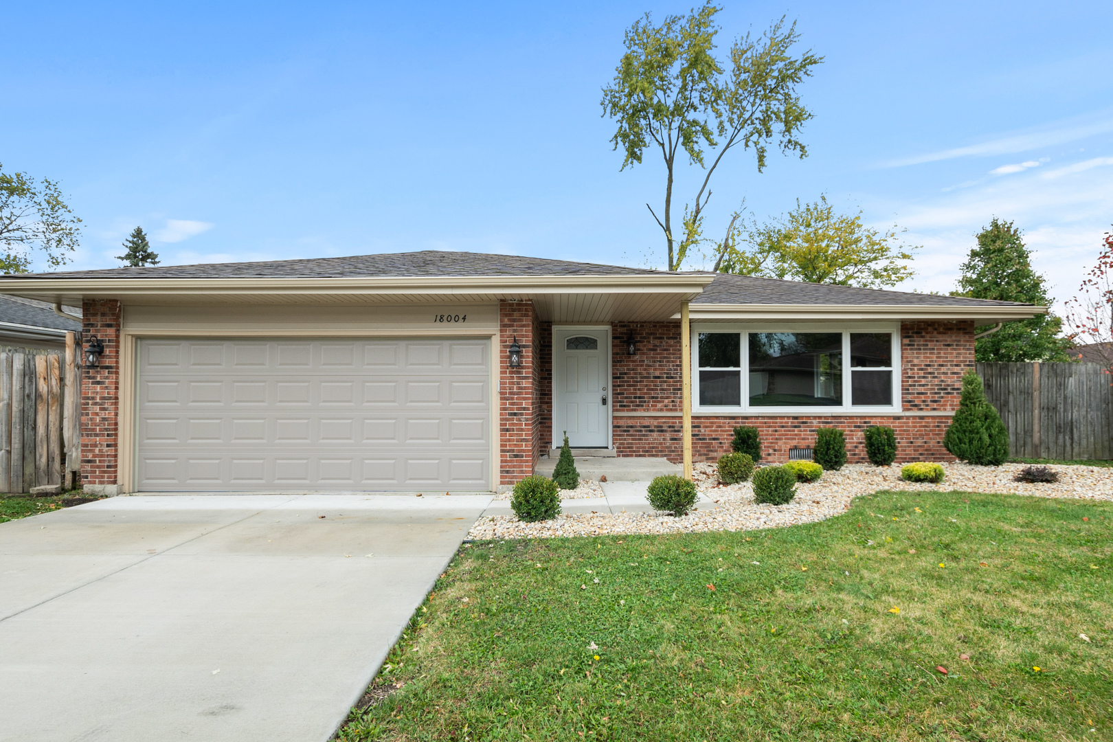 a front view of a house with a yard and porch