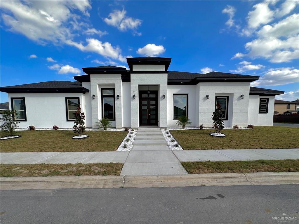 Prairie-style home featuring a front lawn