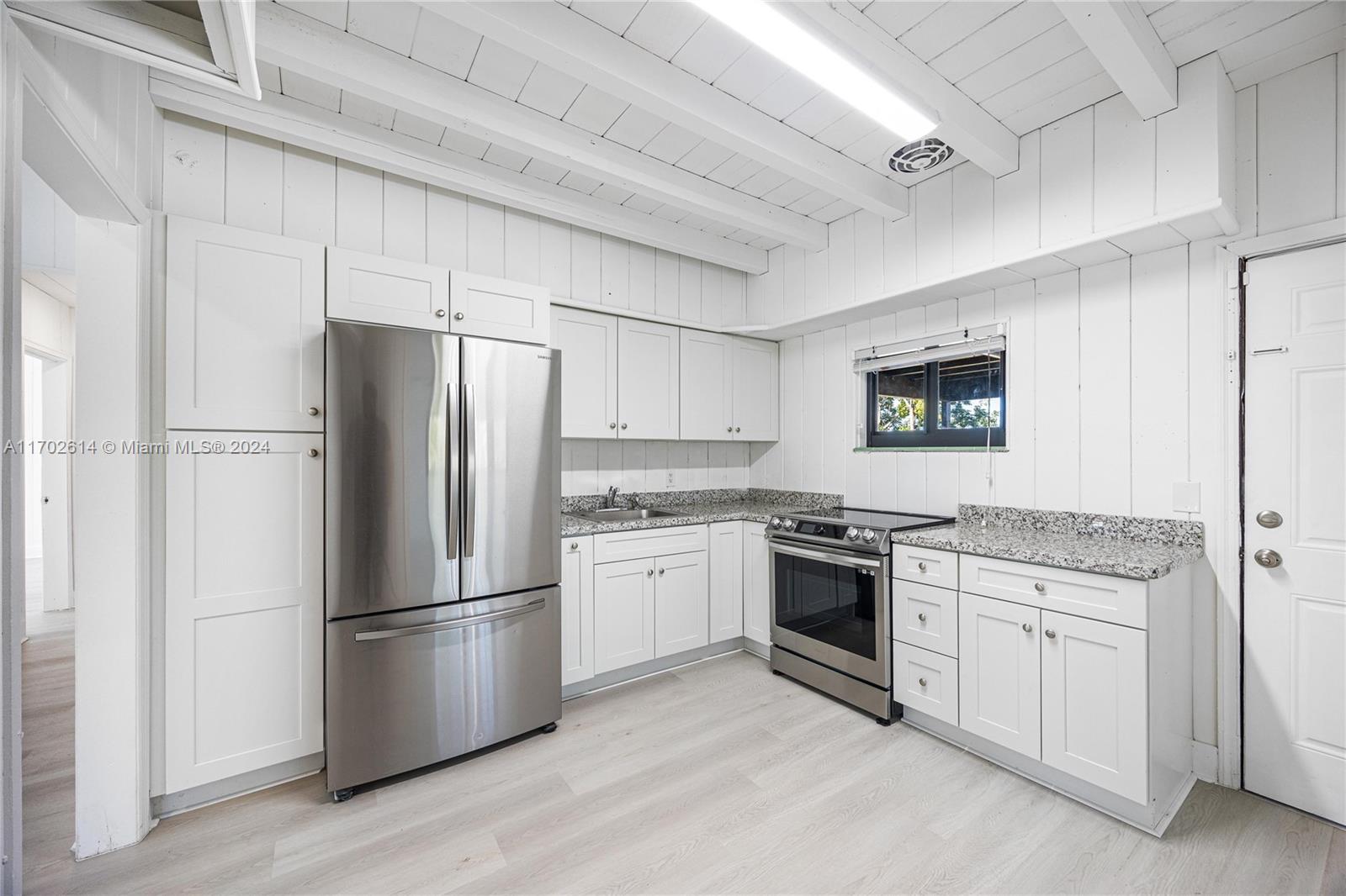 a kitchen with a refrigerator sink and stainless steel appliances