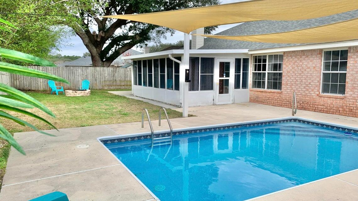 a view of a house with backyard and sitting area