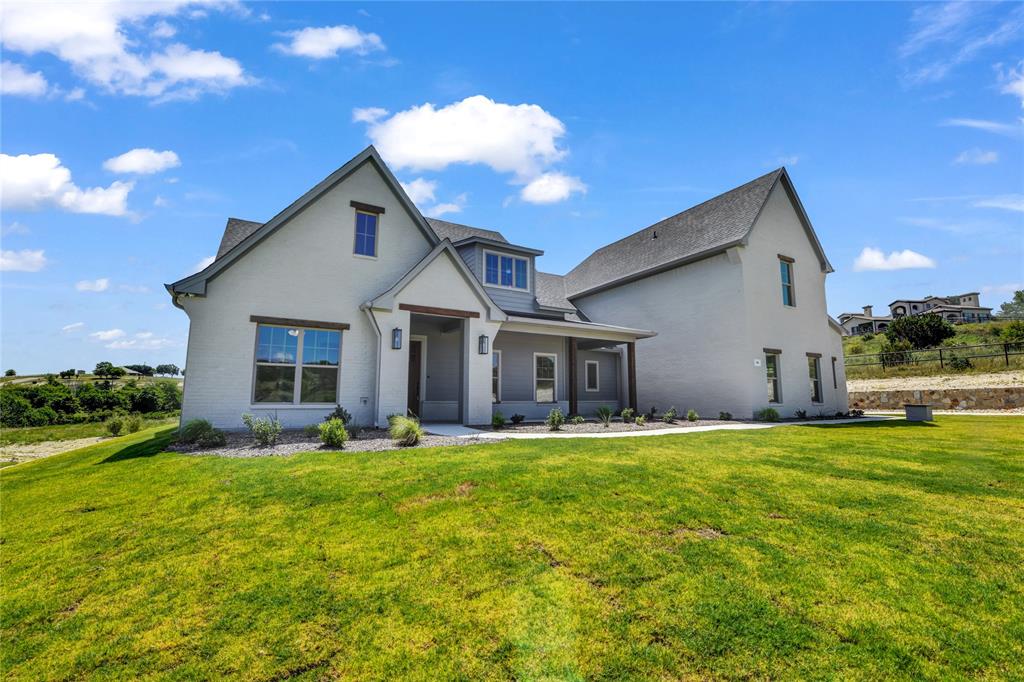 a view of a house with a yard and garage