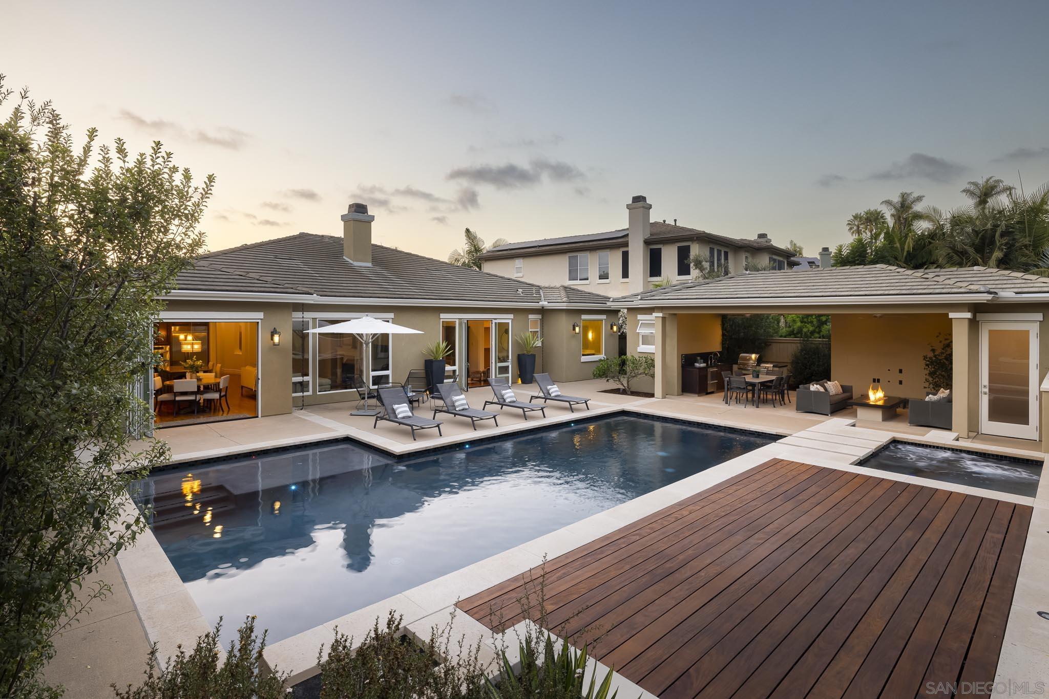 a front view of a house with swimming pool and porch