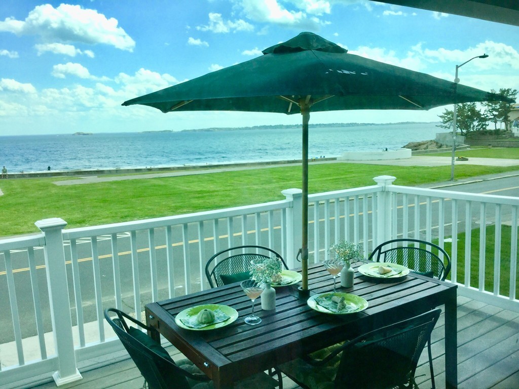 a view of a deck with furniture and yard