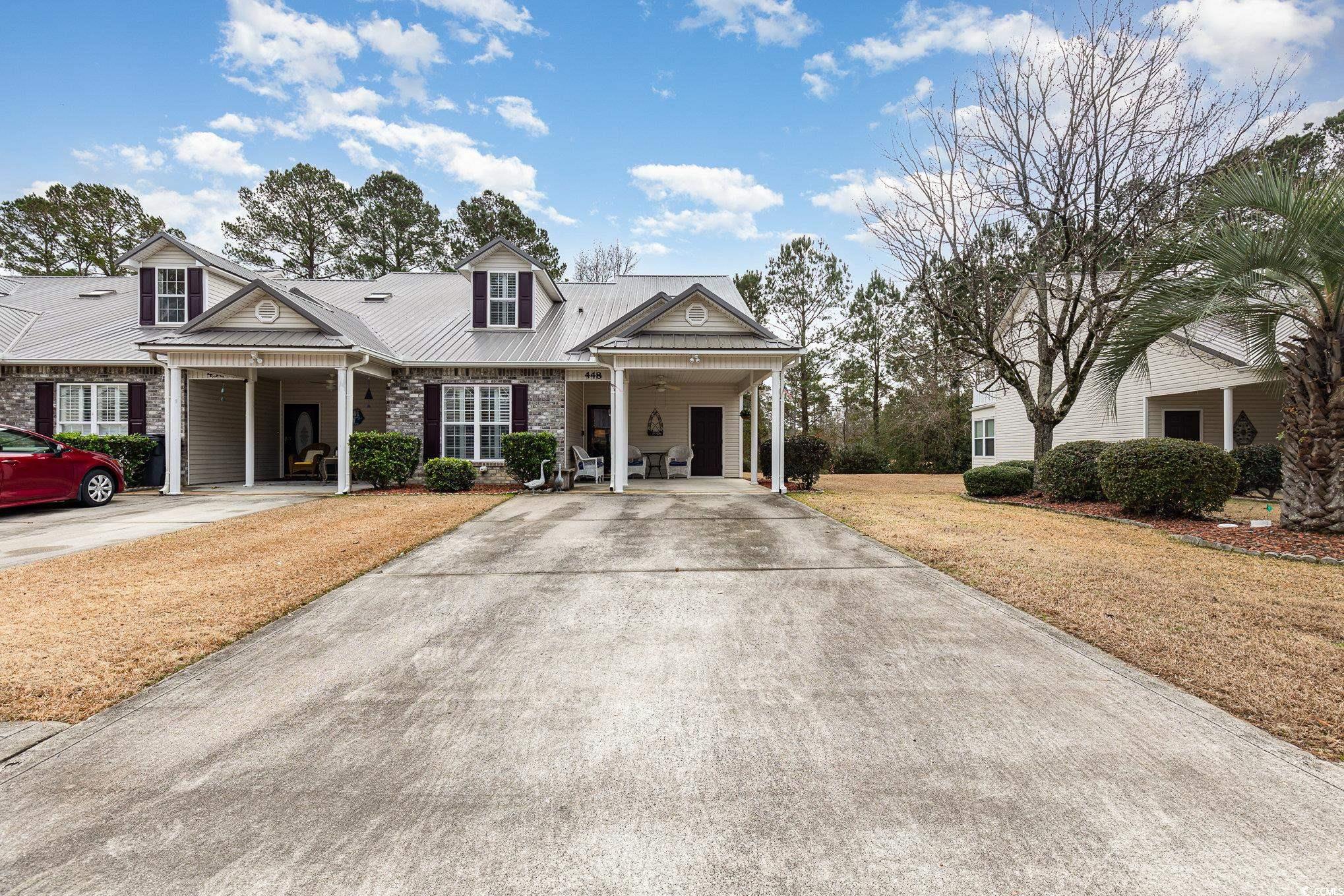 View of front of property with a carport and a fro