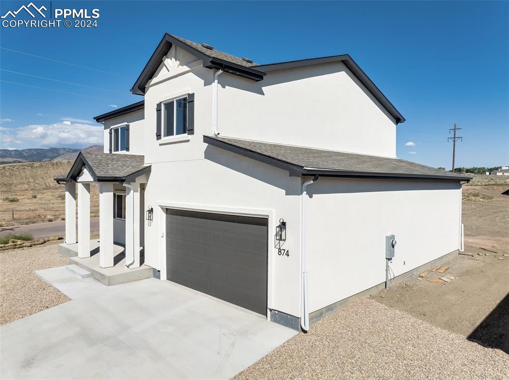 a front view of a house with garage