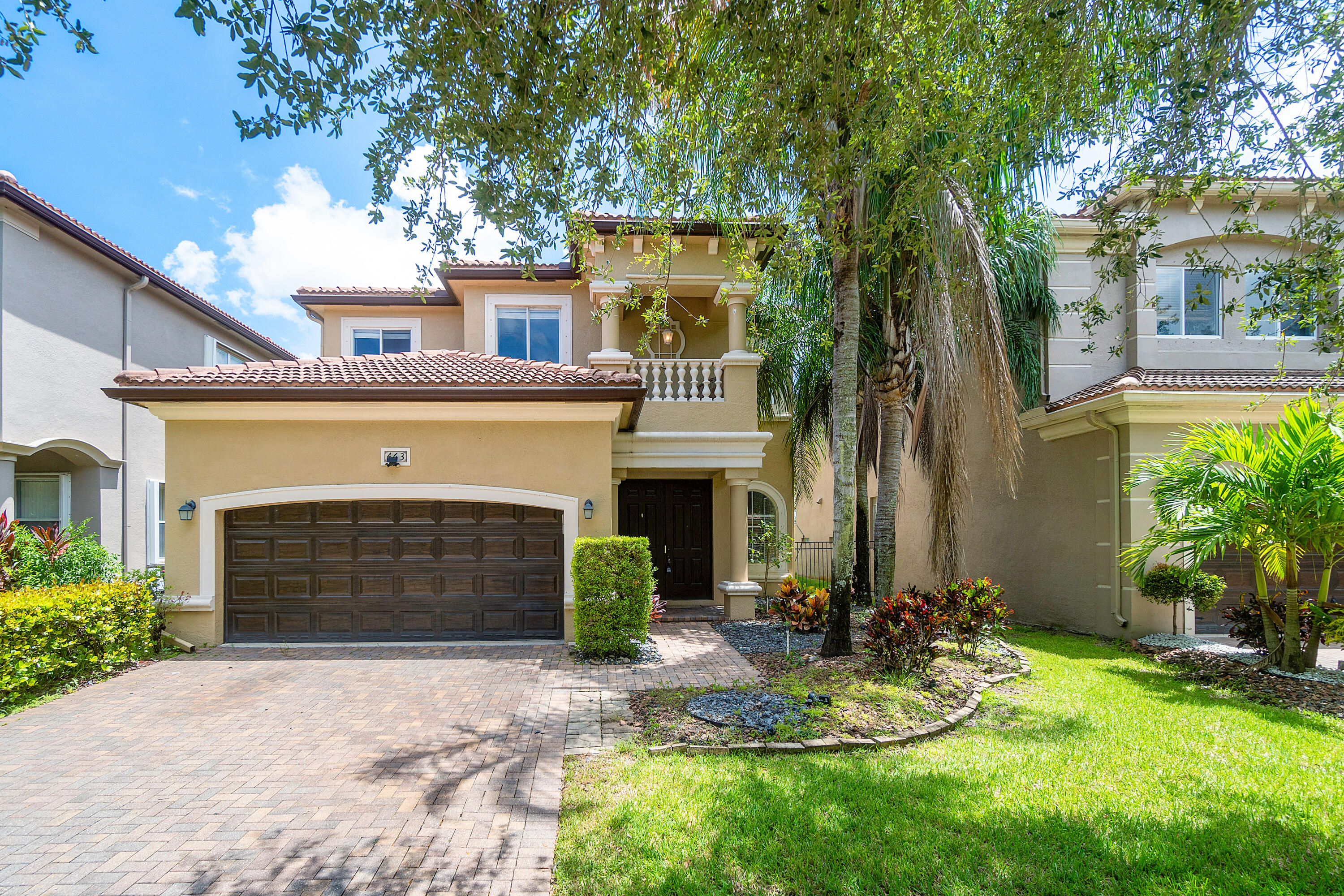 a front view of a house with yard and parking