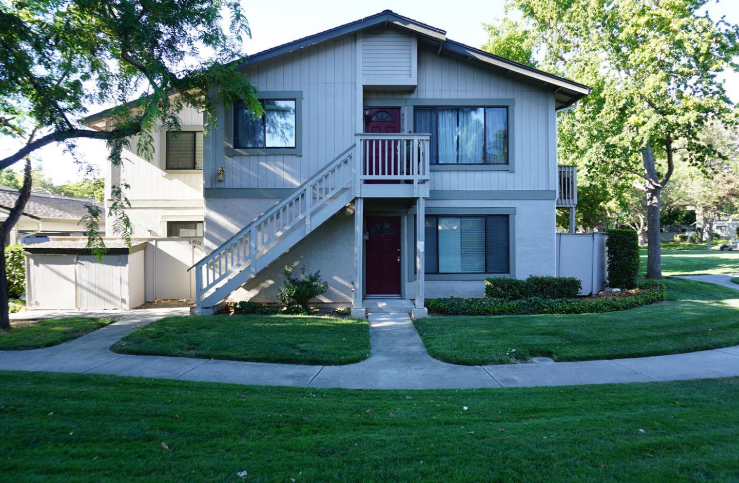 a view of a house with a yard and plants