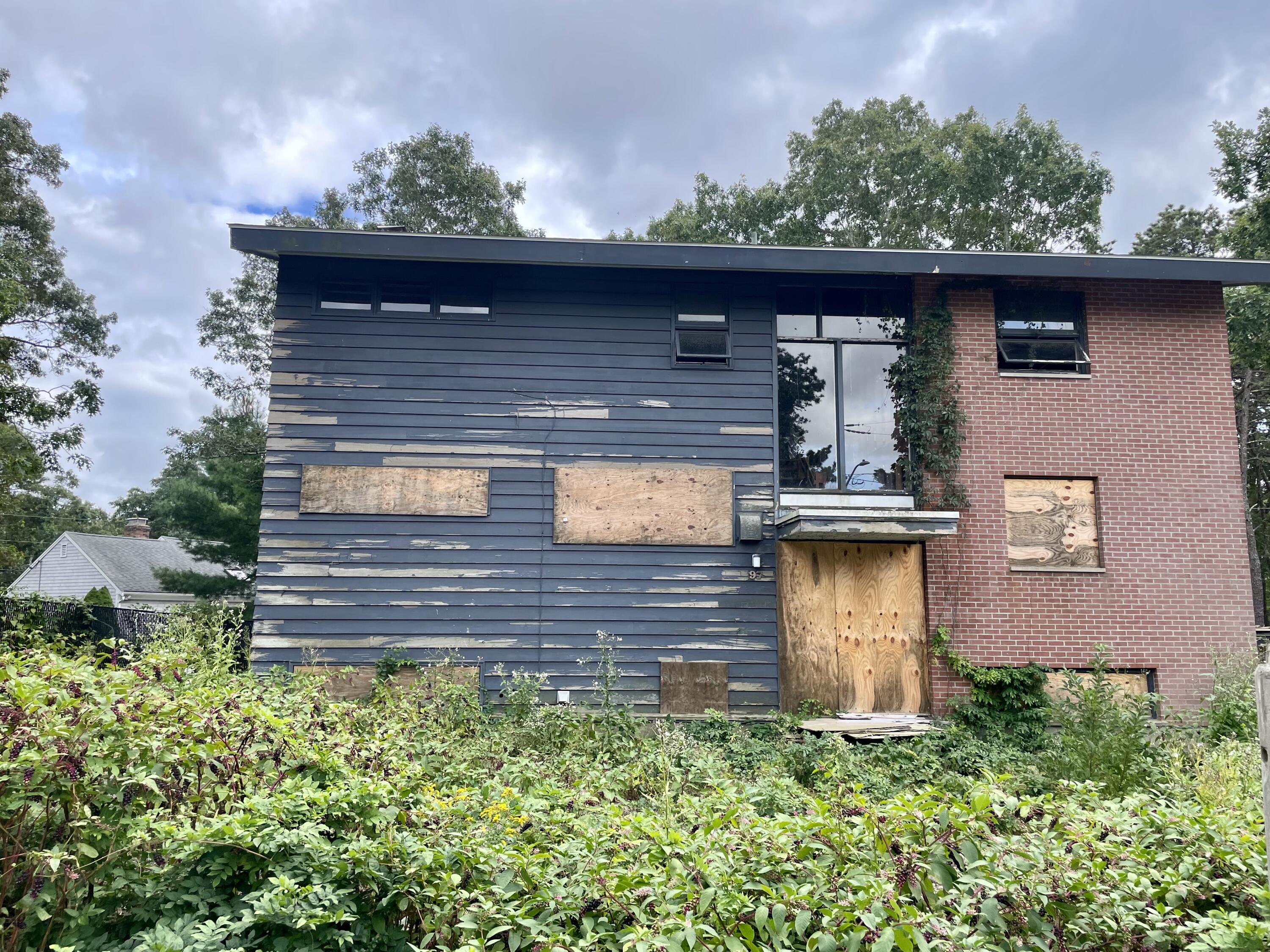 a front view of a house with a garden