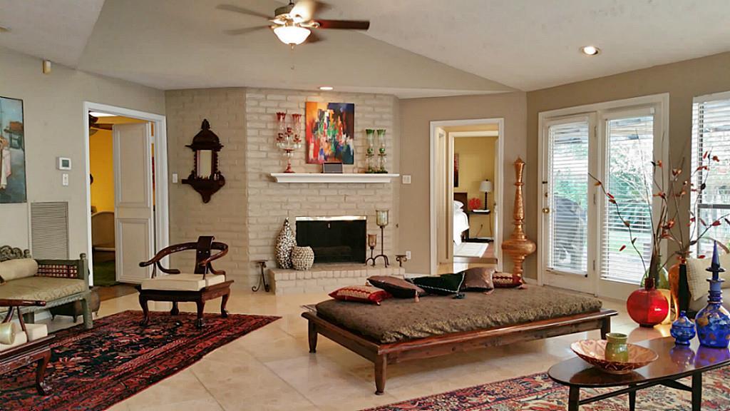 a living room with furniture fireplace and window