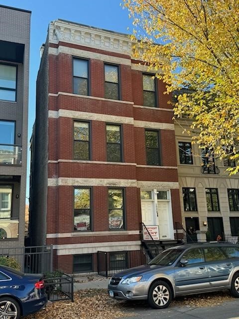 a front view of a residential apartment building with a yard