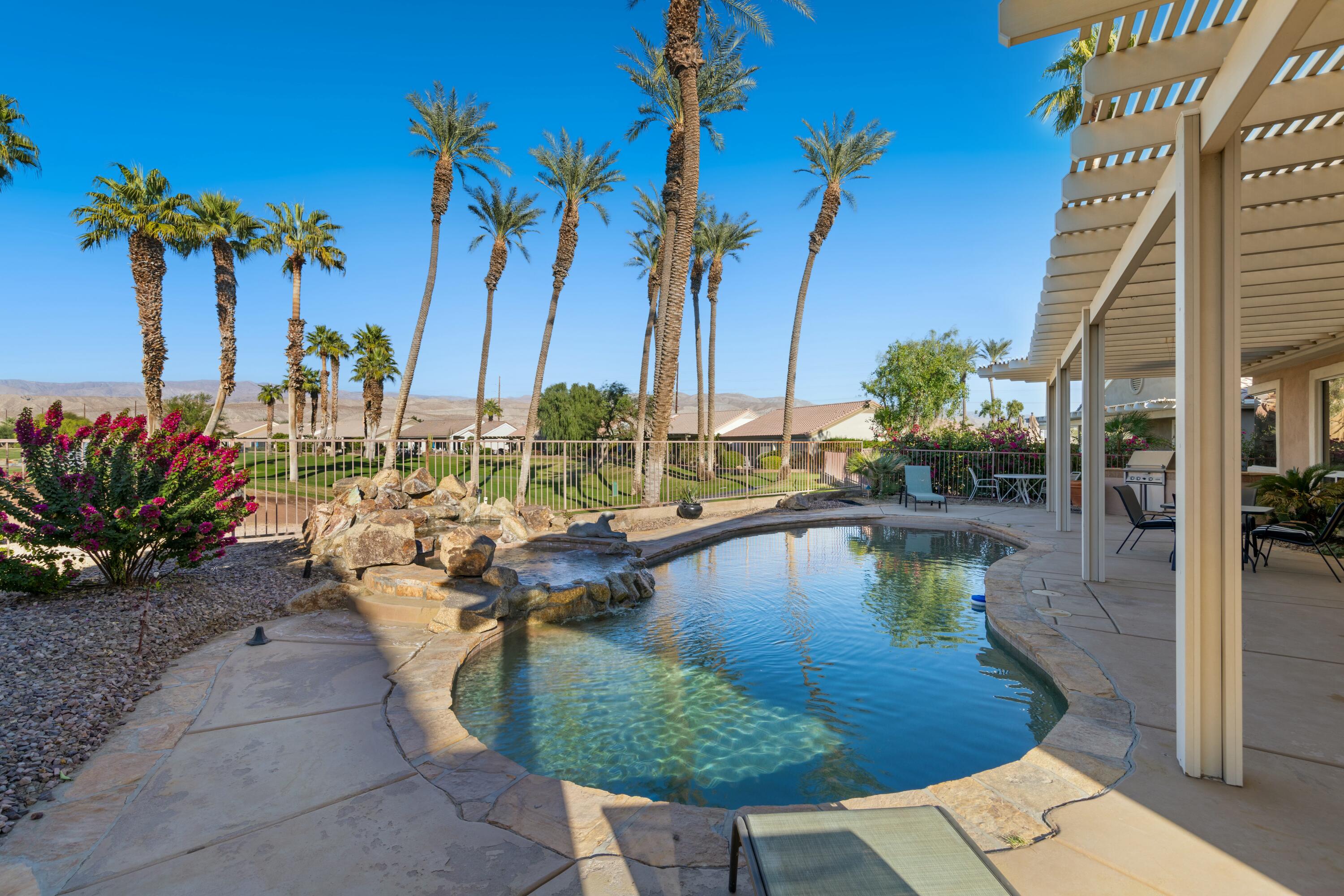 a view of a swimming pool with a table and chairs