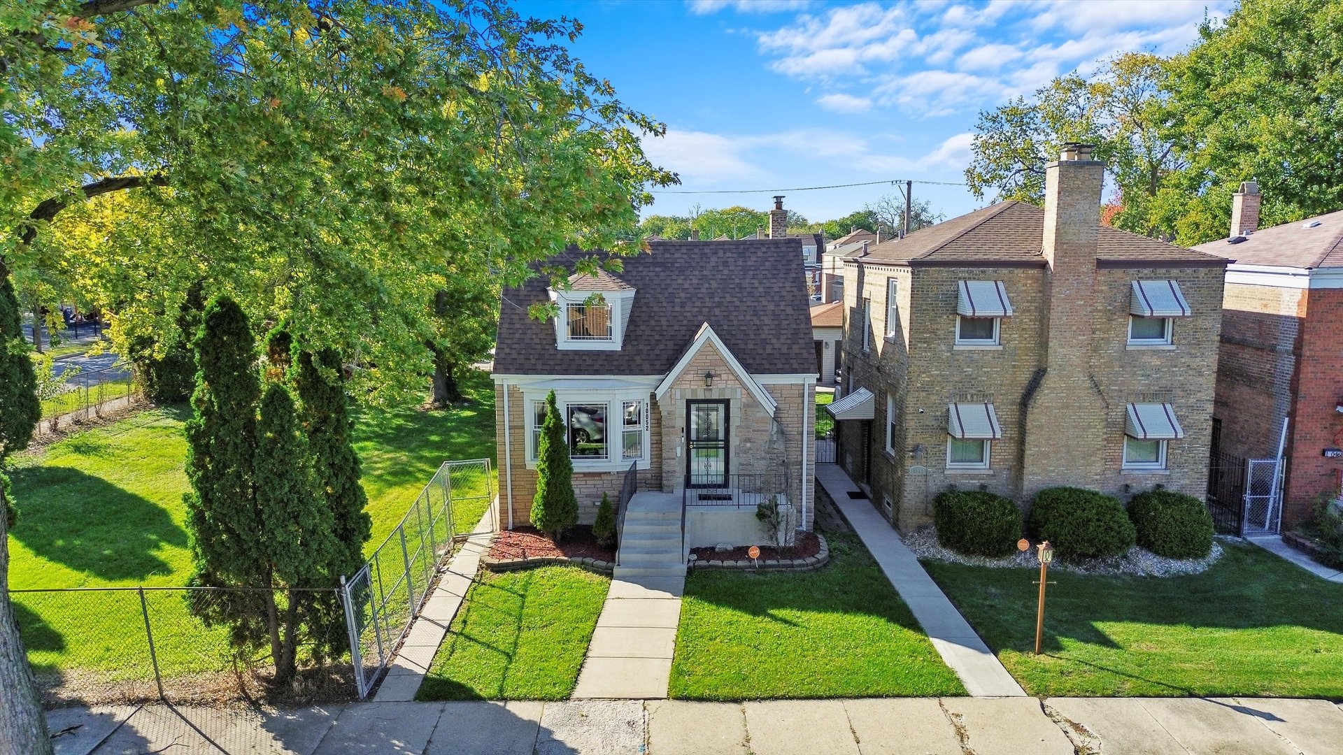 a front view of a house with yard patio and green space