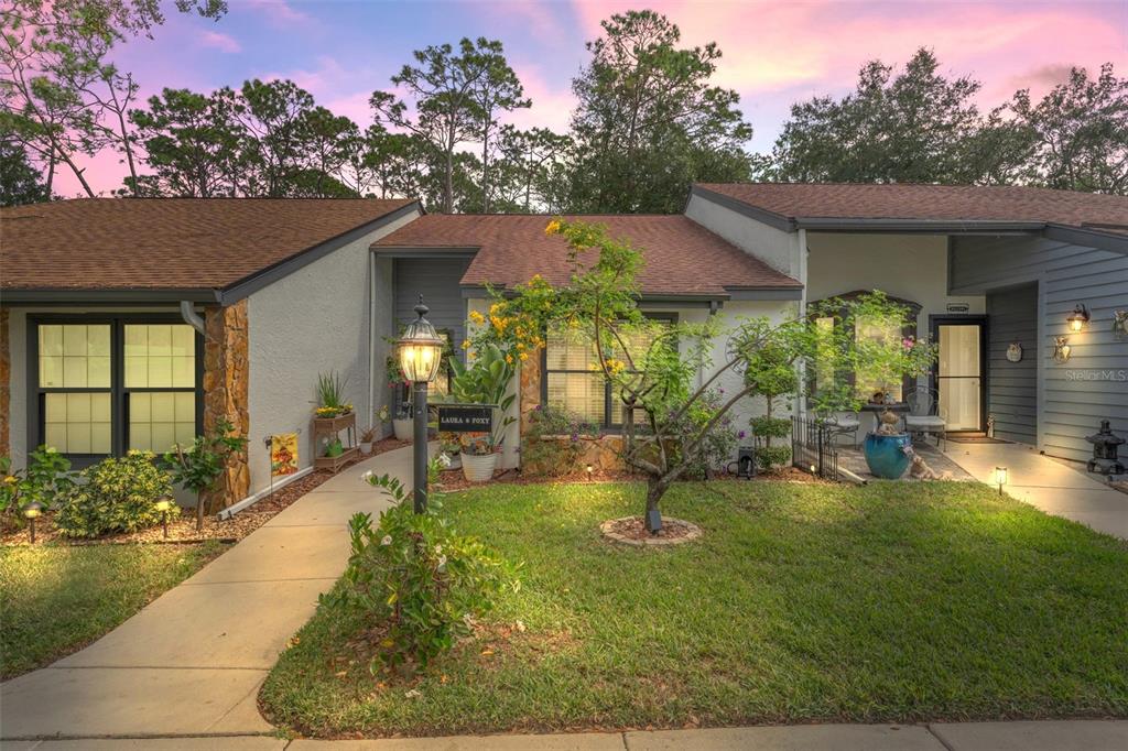 a view of a house with backyard porch and sitting area