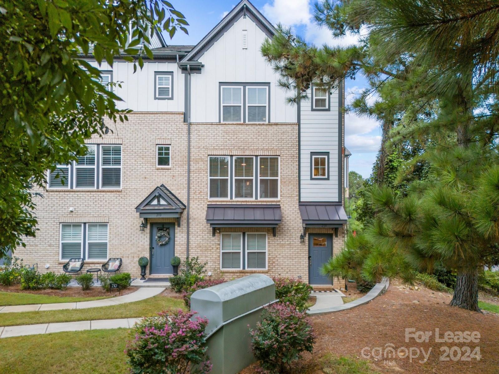 a front view of a residential apartment building with a yard