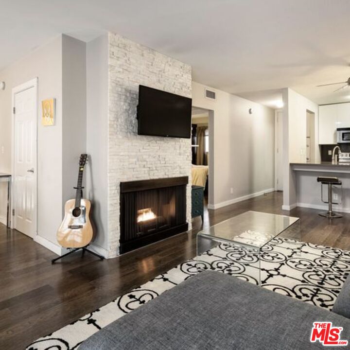 a living room with furniture a flat screen tv and a fireplace