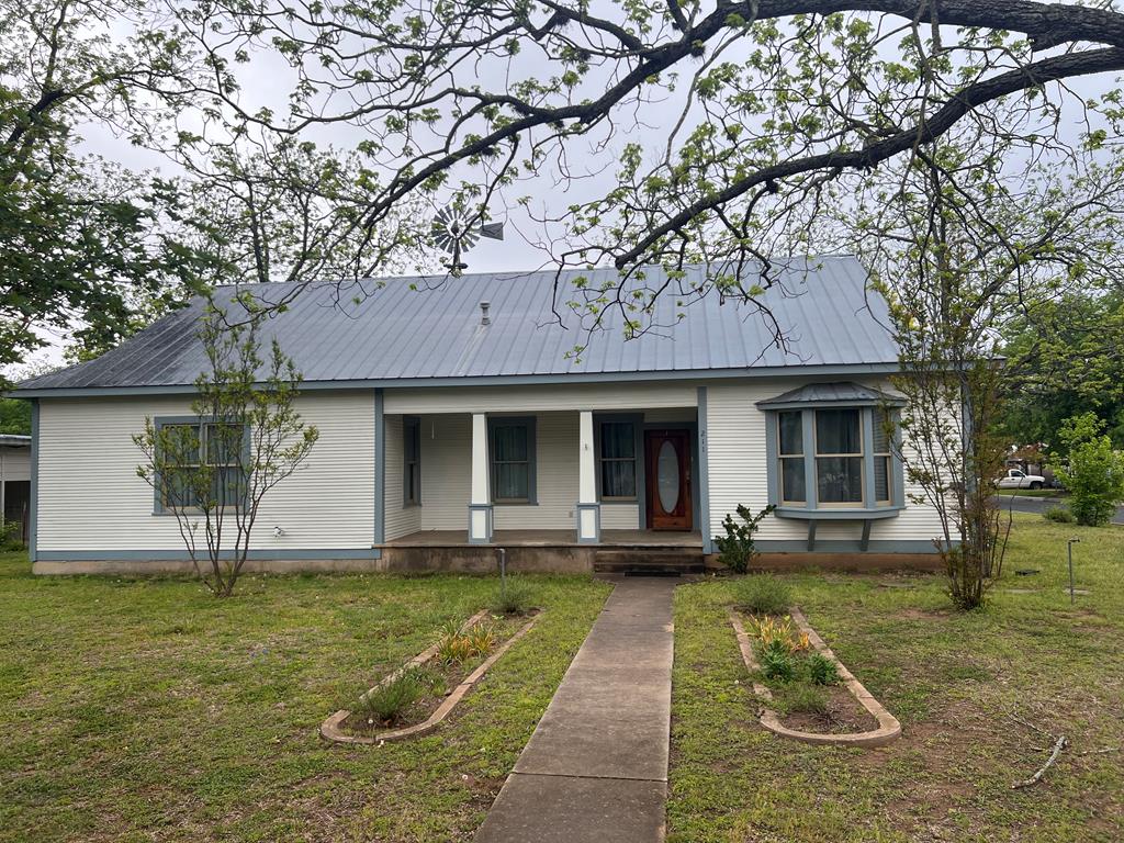 a front view of a house with a yard table and chairs