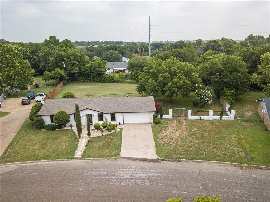 an aerial view of a house with a yard basket ball court and outdoor seating