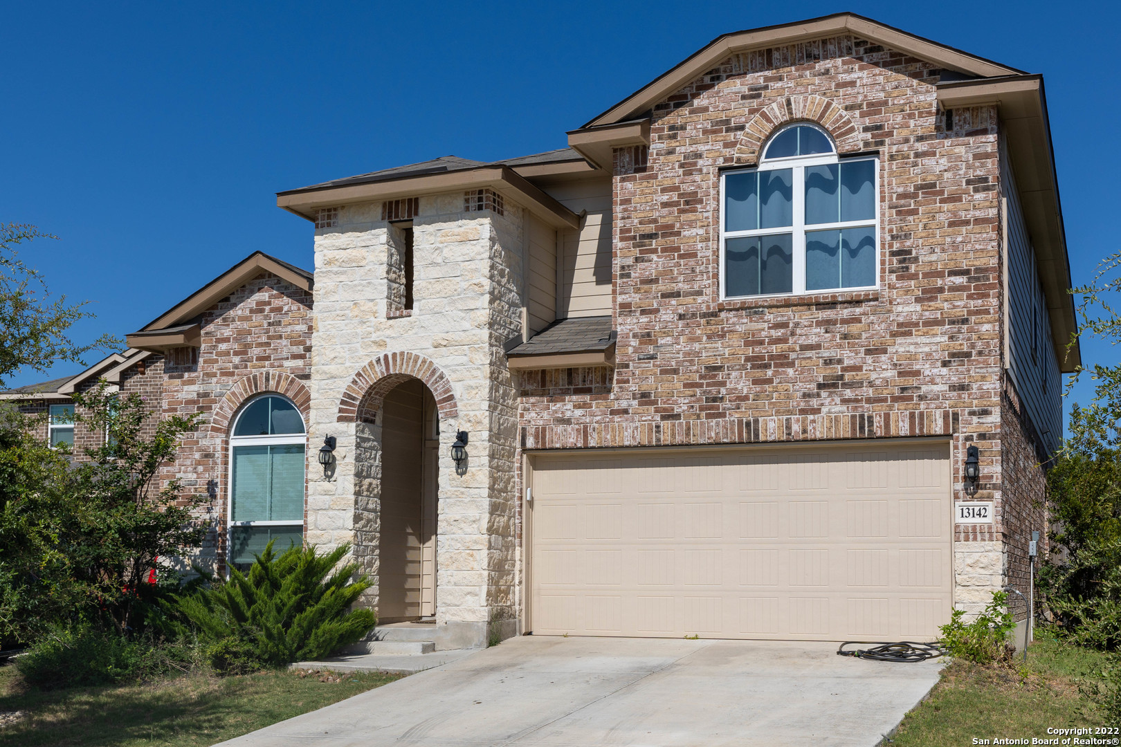 a front view of a house with a yard