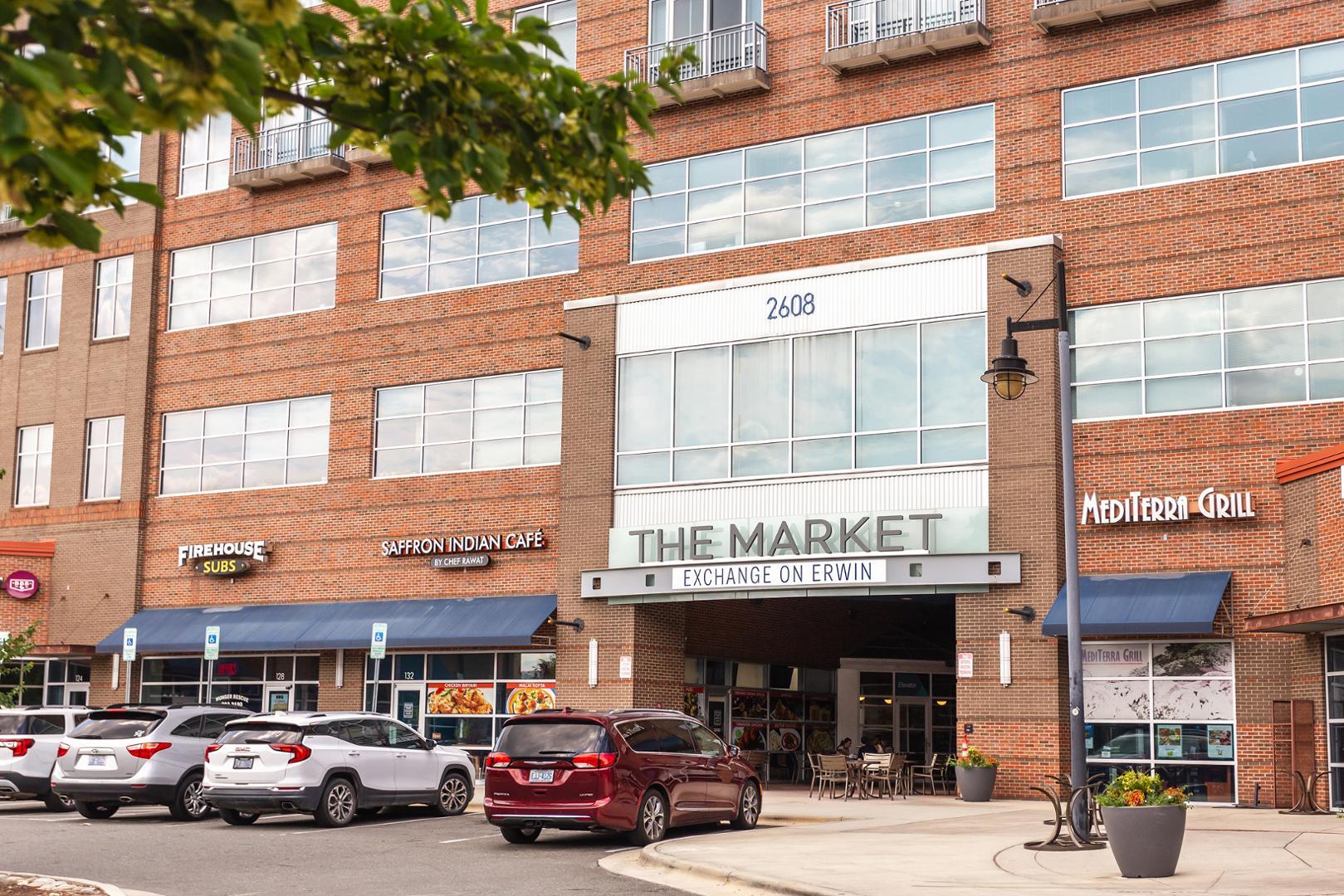 a view of a cars park in front of a building