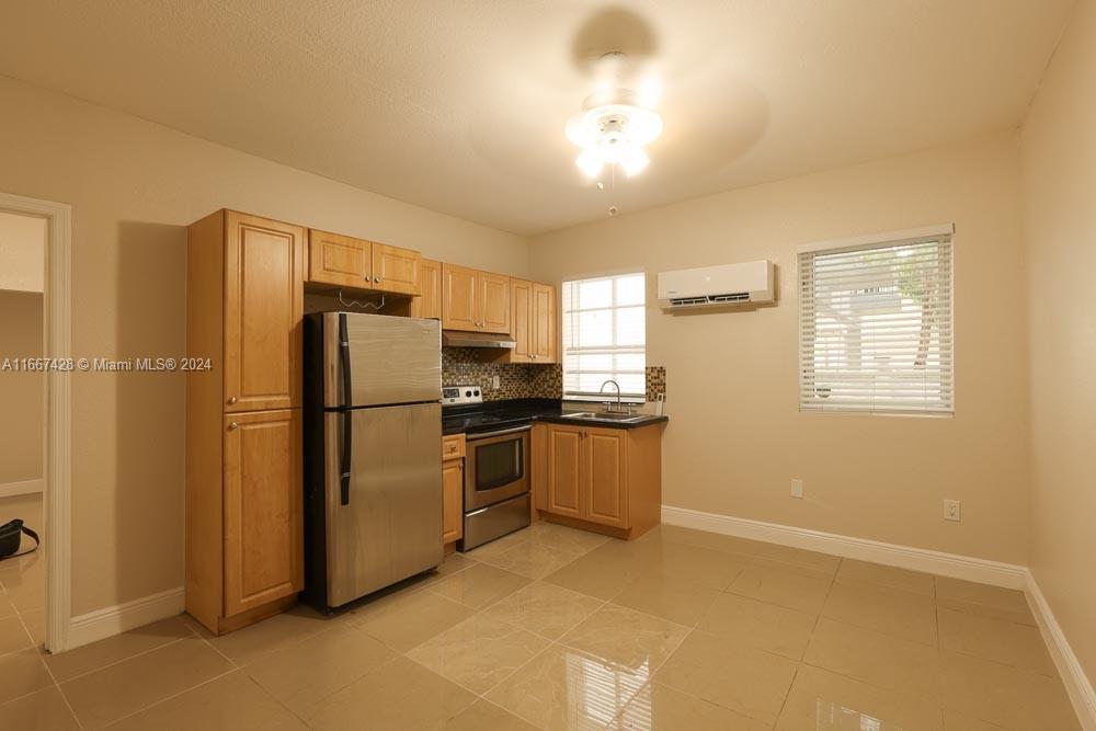 a kitchen with stainless steel appliances a refrigerator and a stove