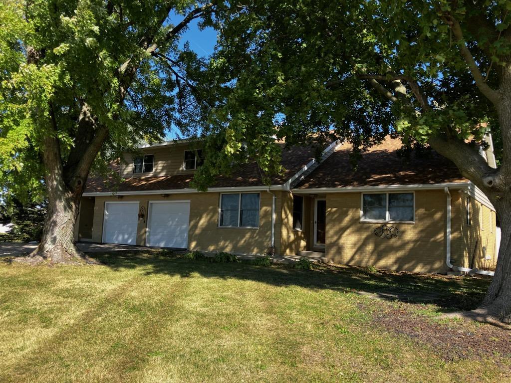 a view of backyard with wooden fence and a tree