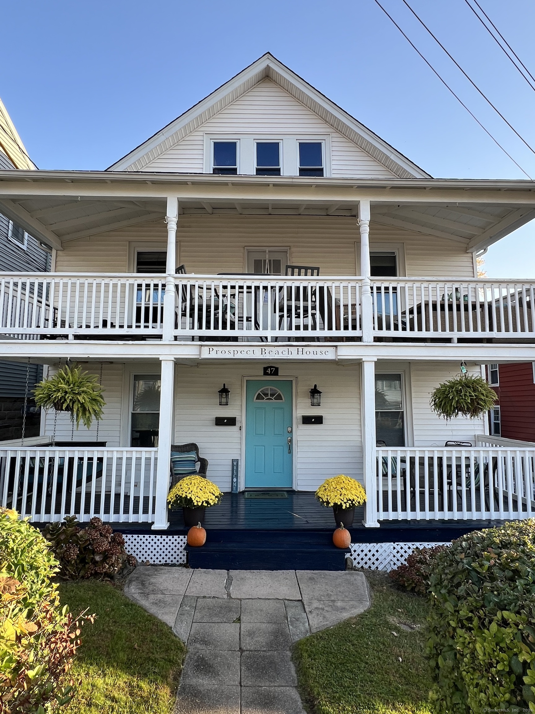 a view of a house with wooden deck and furniture