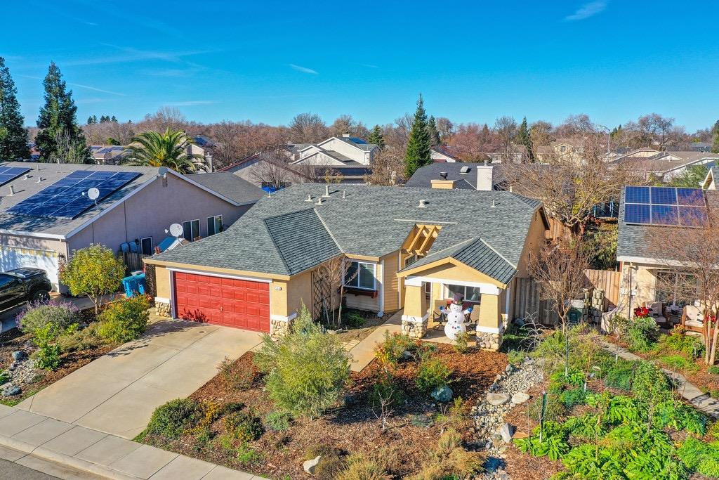 an aerial view of multiple houses with a yard